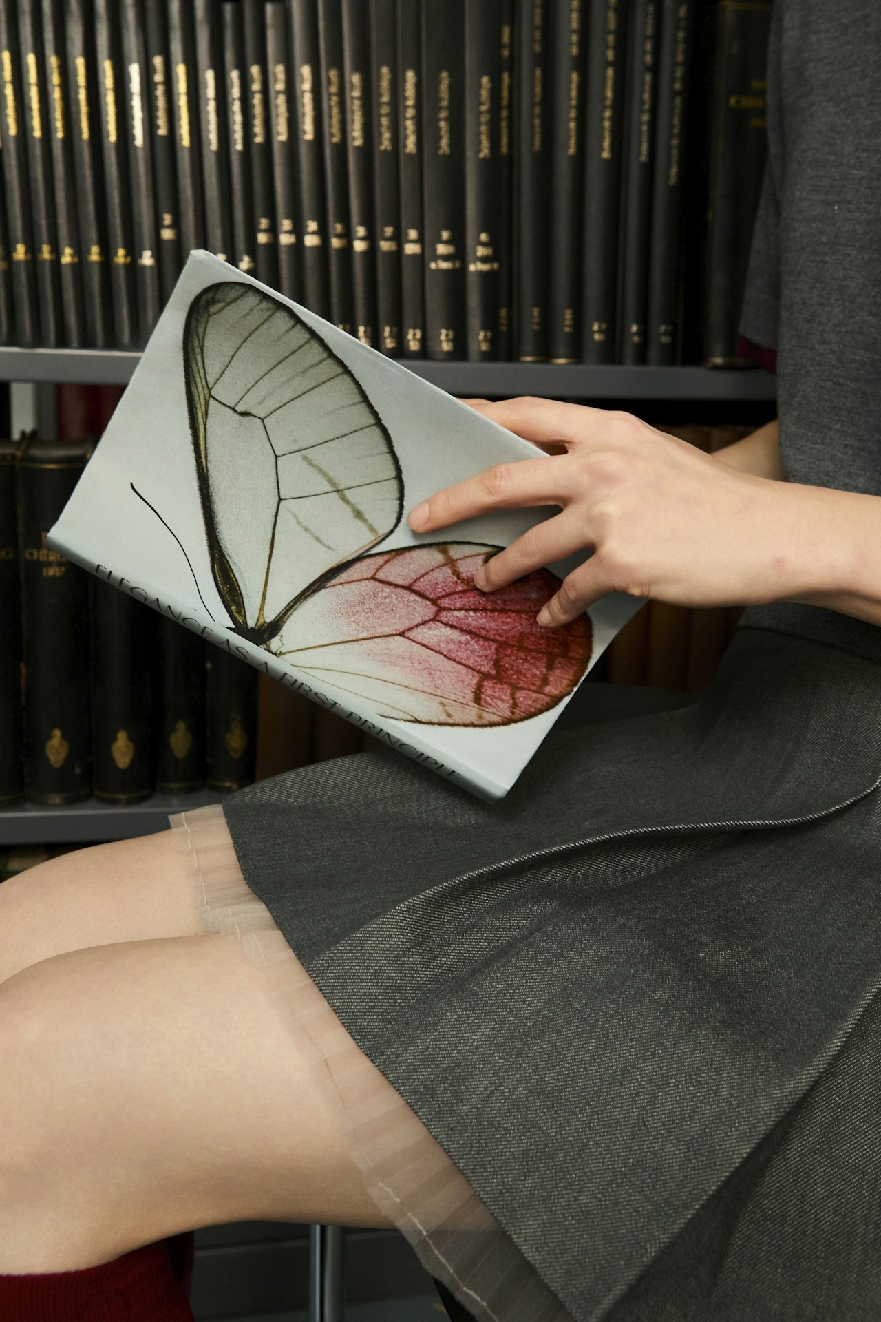 Girl Reading Book with Butterfly Cover