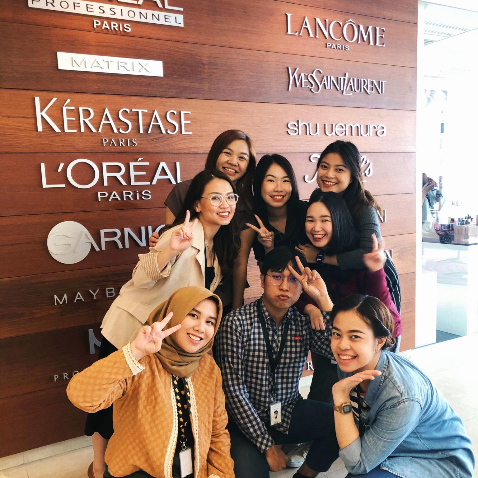 Girl peeking over laptop displaying daisies