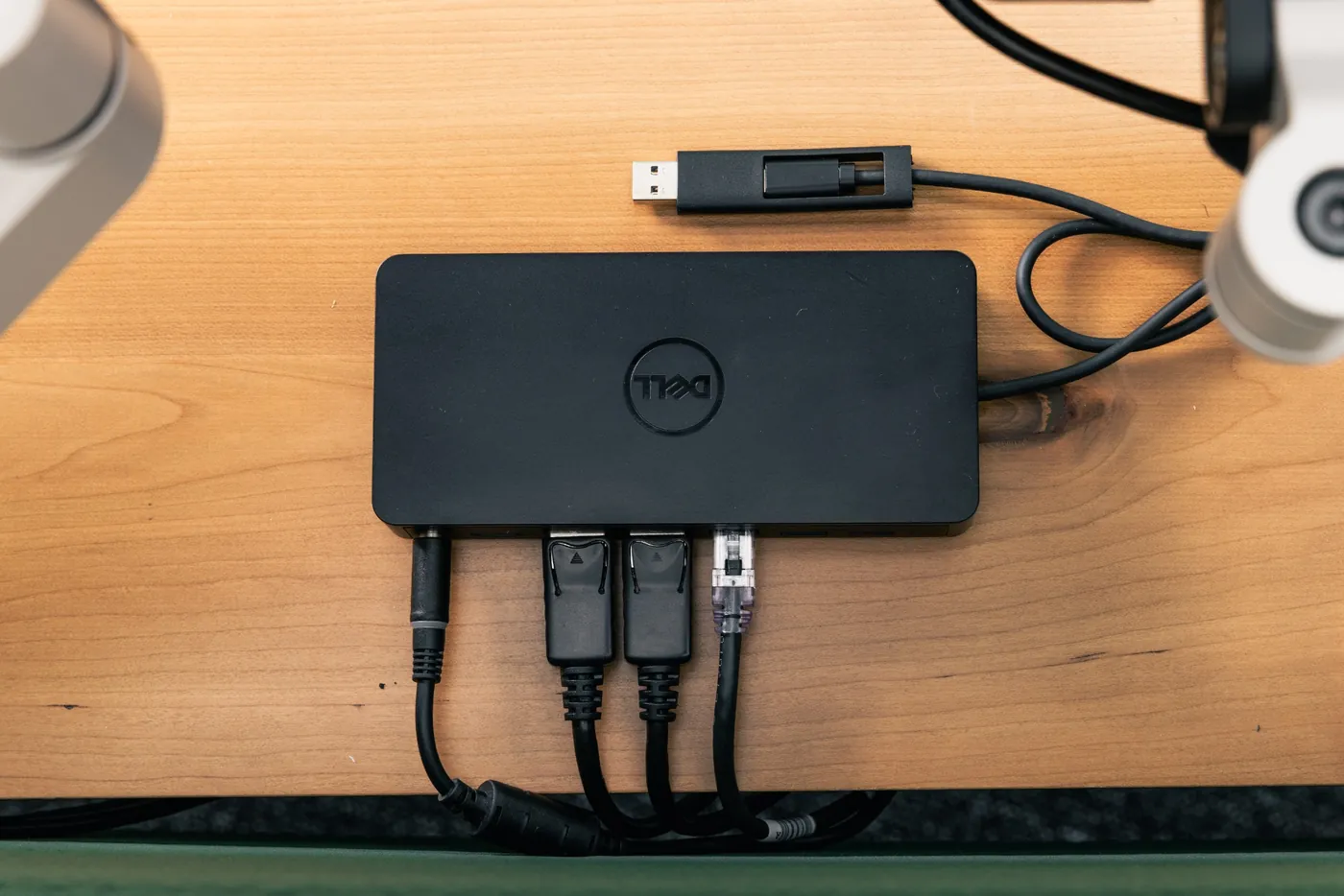 Office workstation docking station setup with HDMI, power, and network connections for efficient IT deployment.