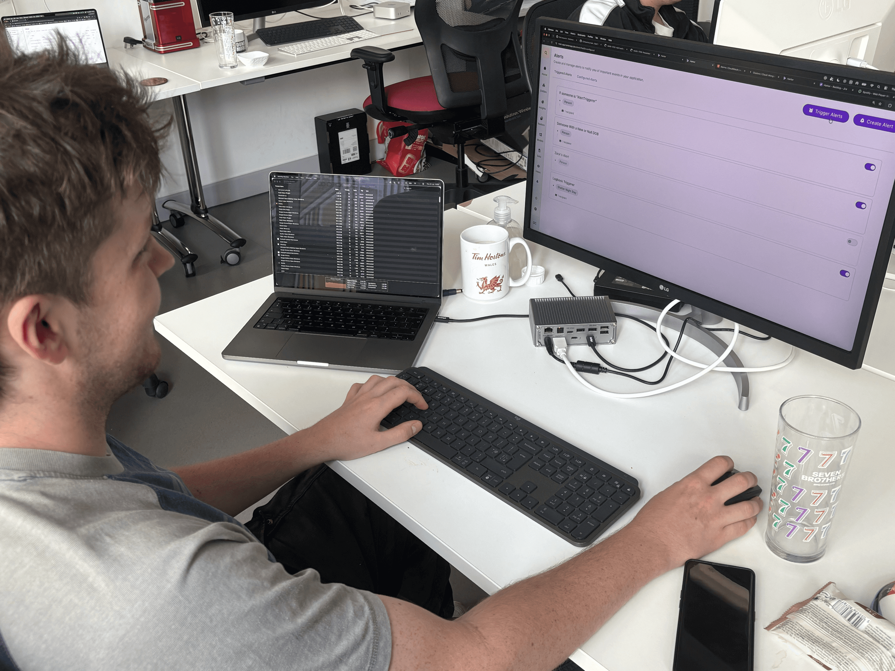 Ollie sat at an office desk working at a computer monitor.