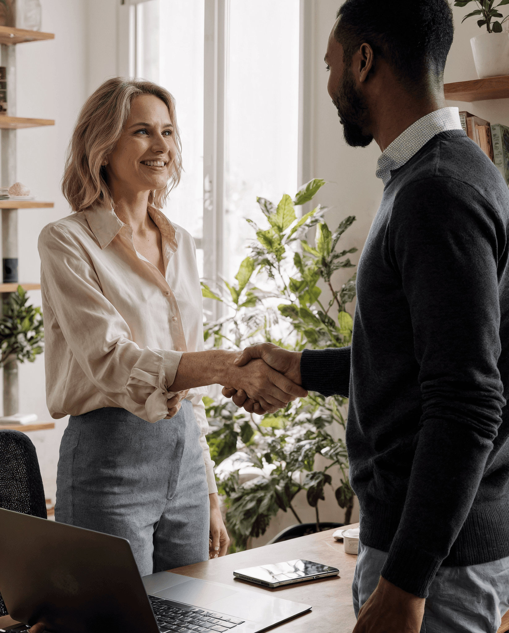 two people looking at a tablet and smiling