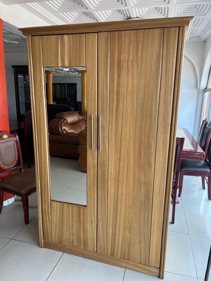 a gray couch with a wooden base on a gray background