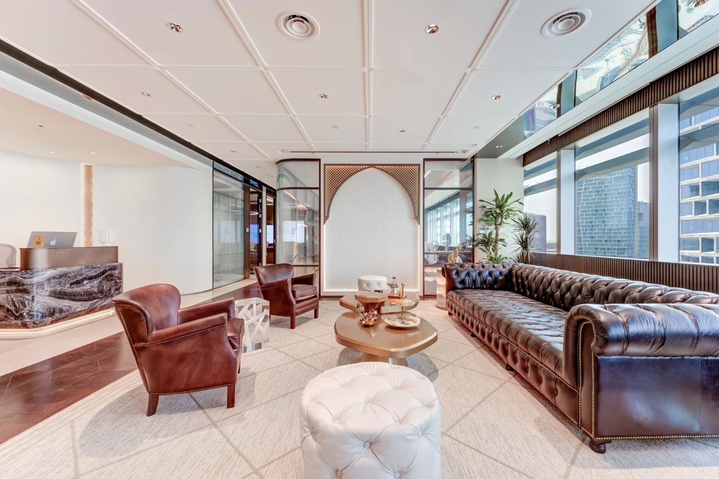 Modern conference space with a long table, ergonomic chairs, and subtle lighting.