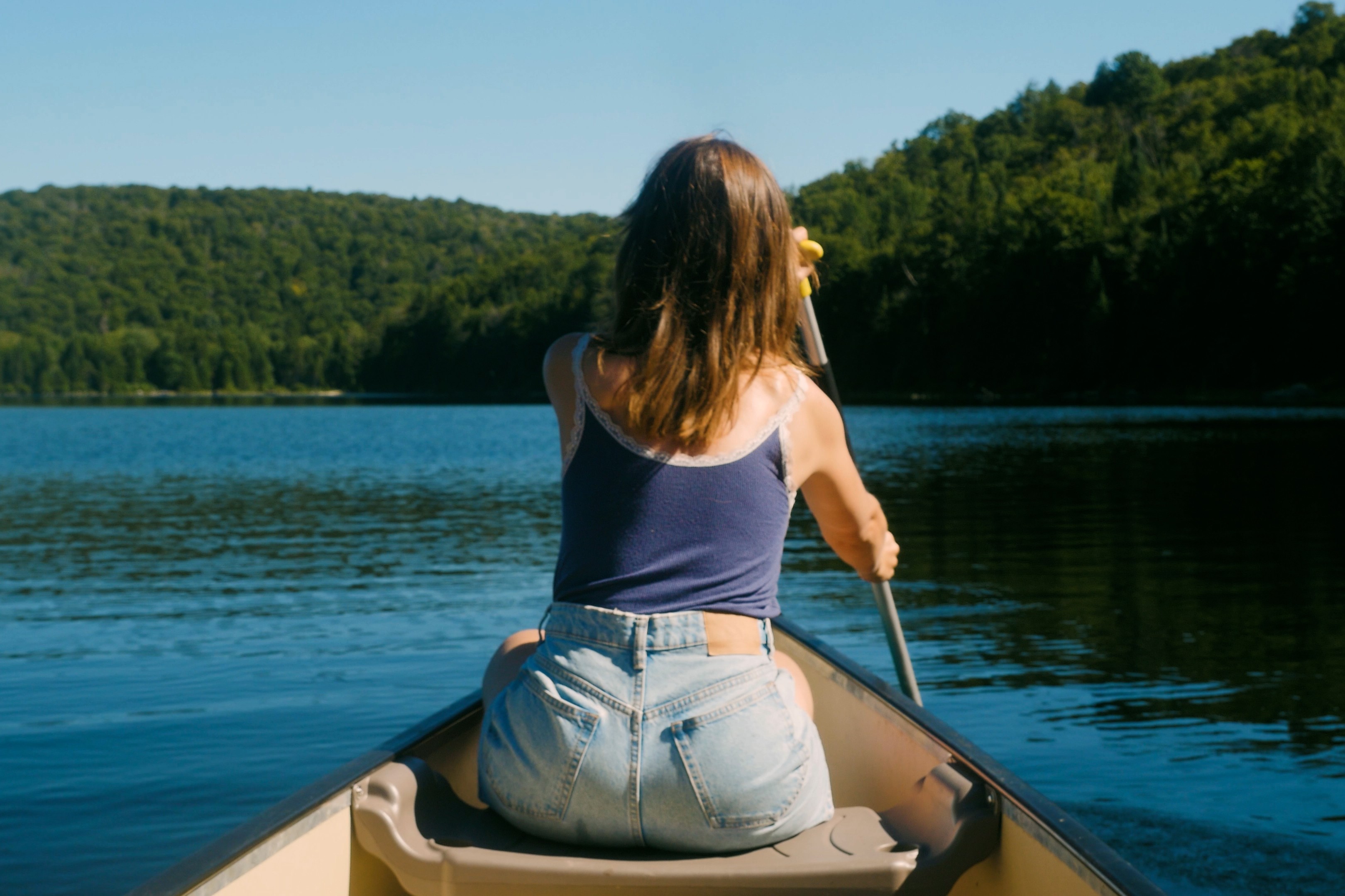 Cinematic visual storytelling film of a woman paddling for La vie au lac creative video in Laurentides, Quebec