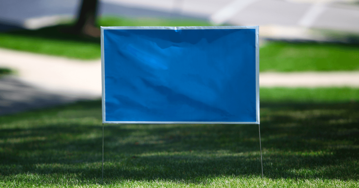 Overhead view of a workspace with a keyboard, notebook, pen, calculator, coffee, and glasses. The notebook has a to-do list and action plan written on it.