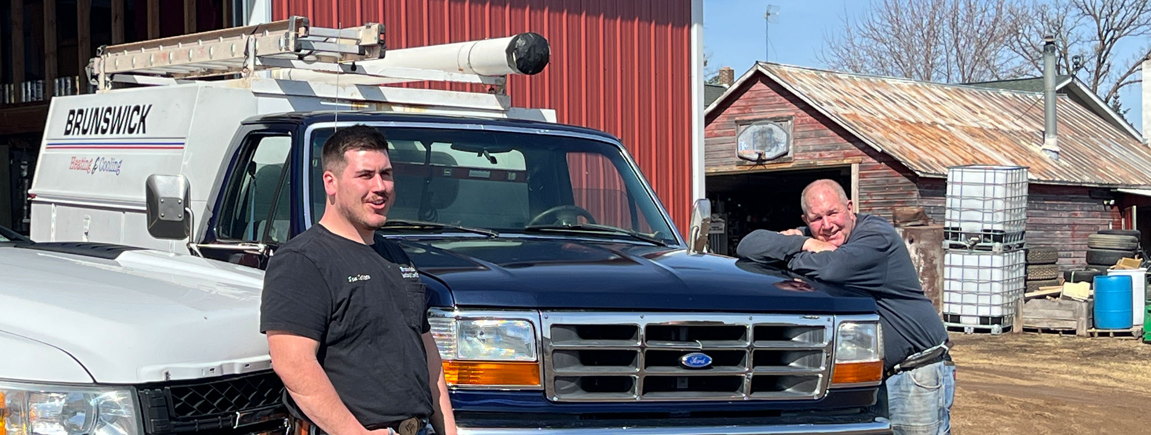 Sam and Dave DeVito standing next tor Brunswick service trucks