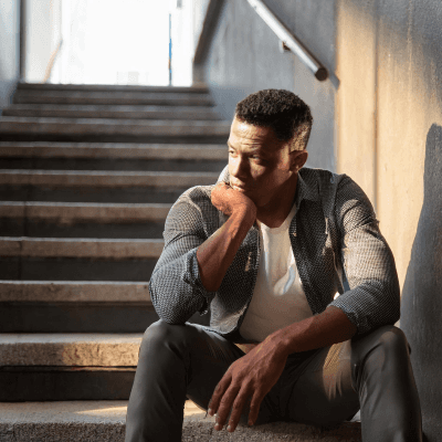 Sitting on the stairs, deep in thought.