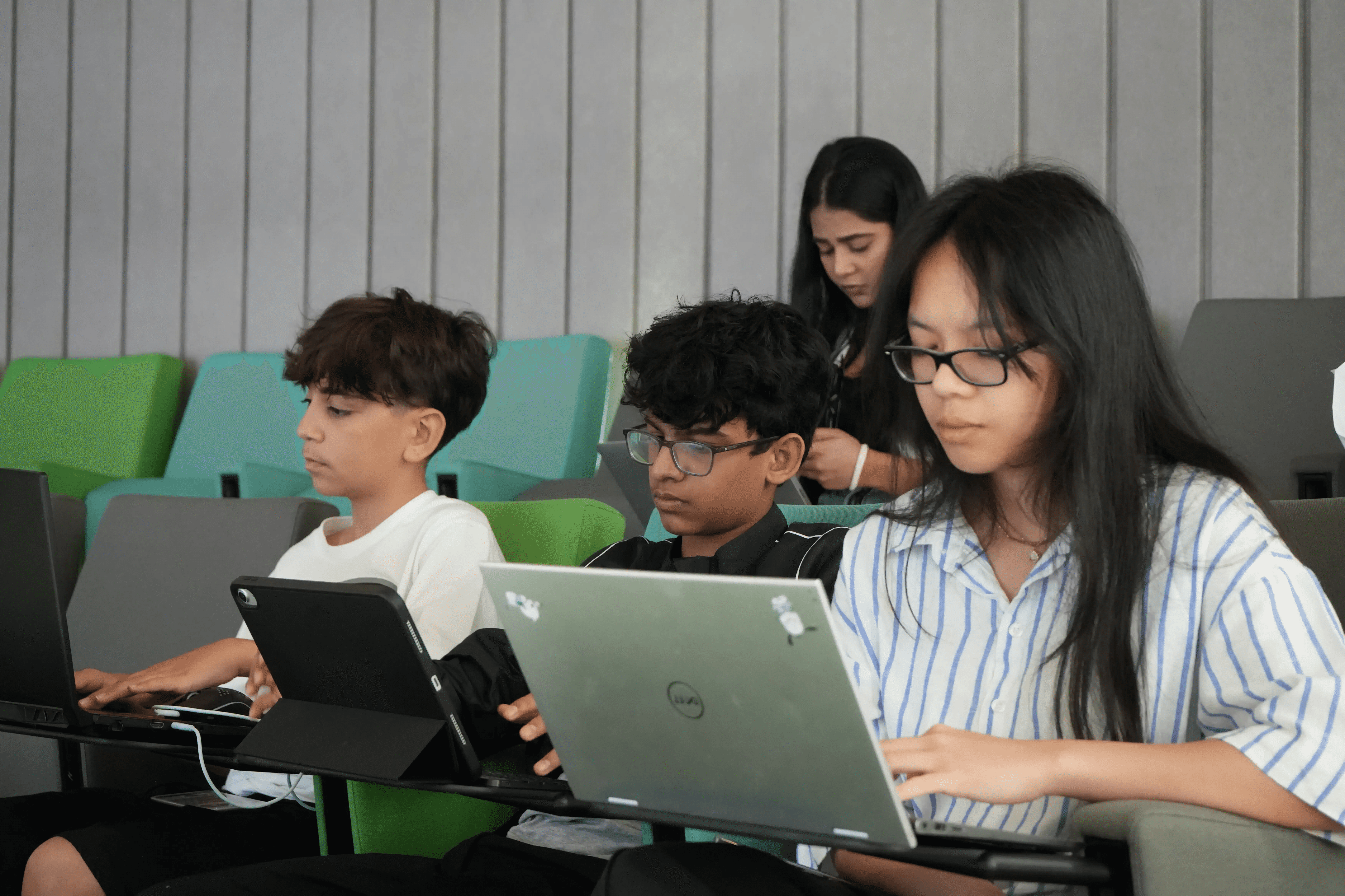 Smiling high school girl engaged in an online tutoring session with her peers at Rise Research