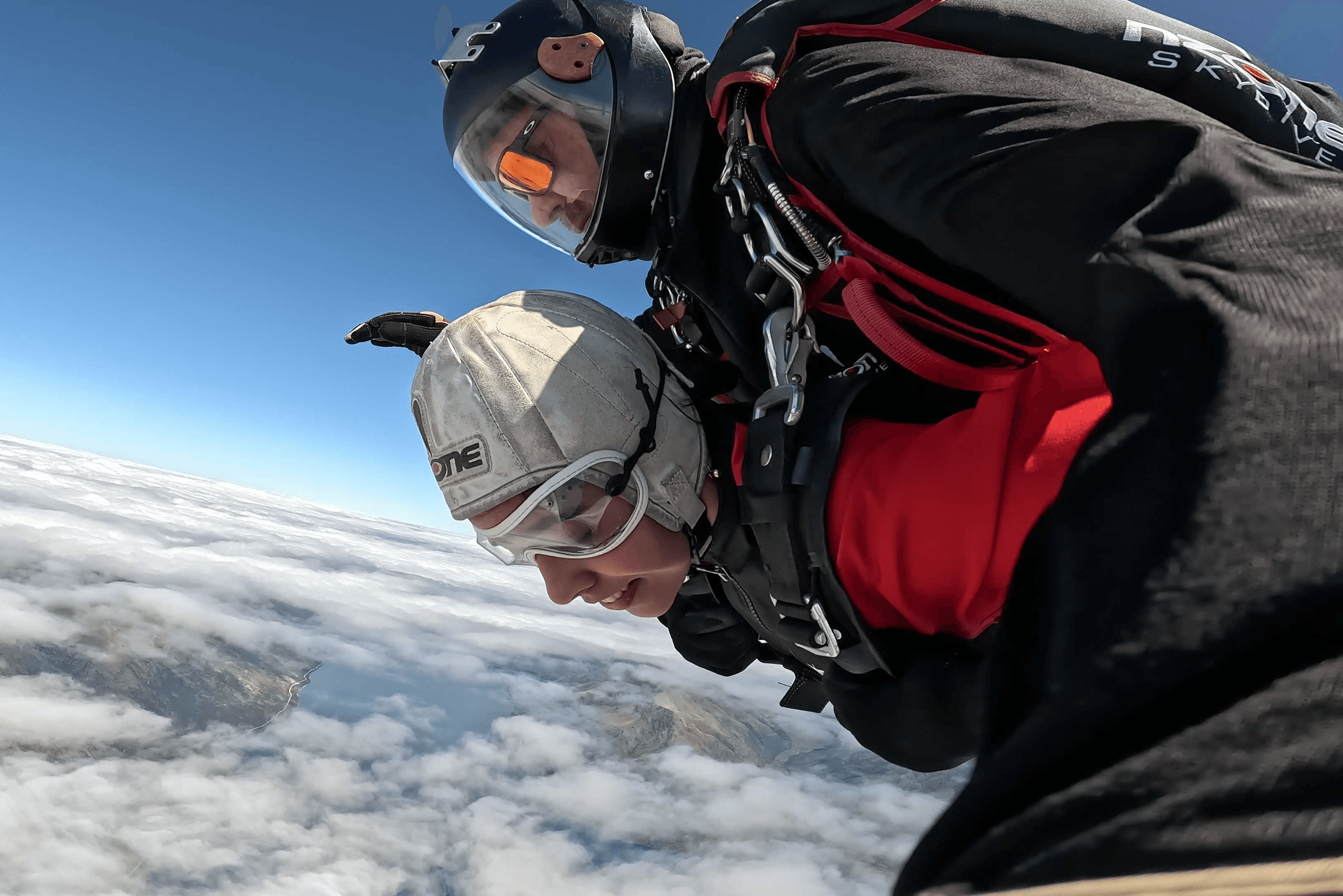 People playing soccer on a rooftop court surrounded by city buildings