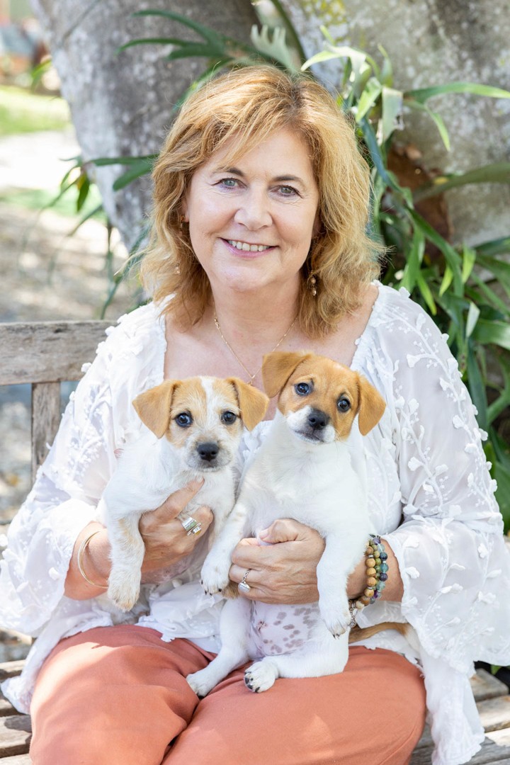 Woman holding two puppies
