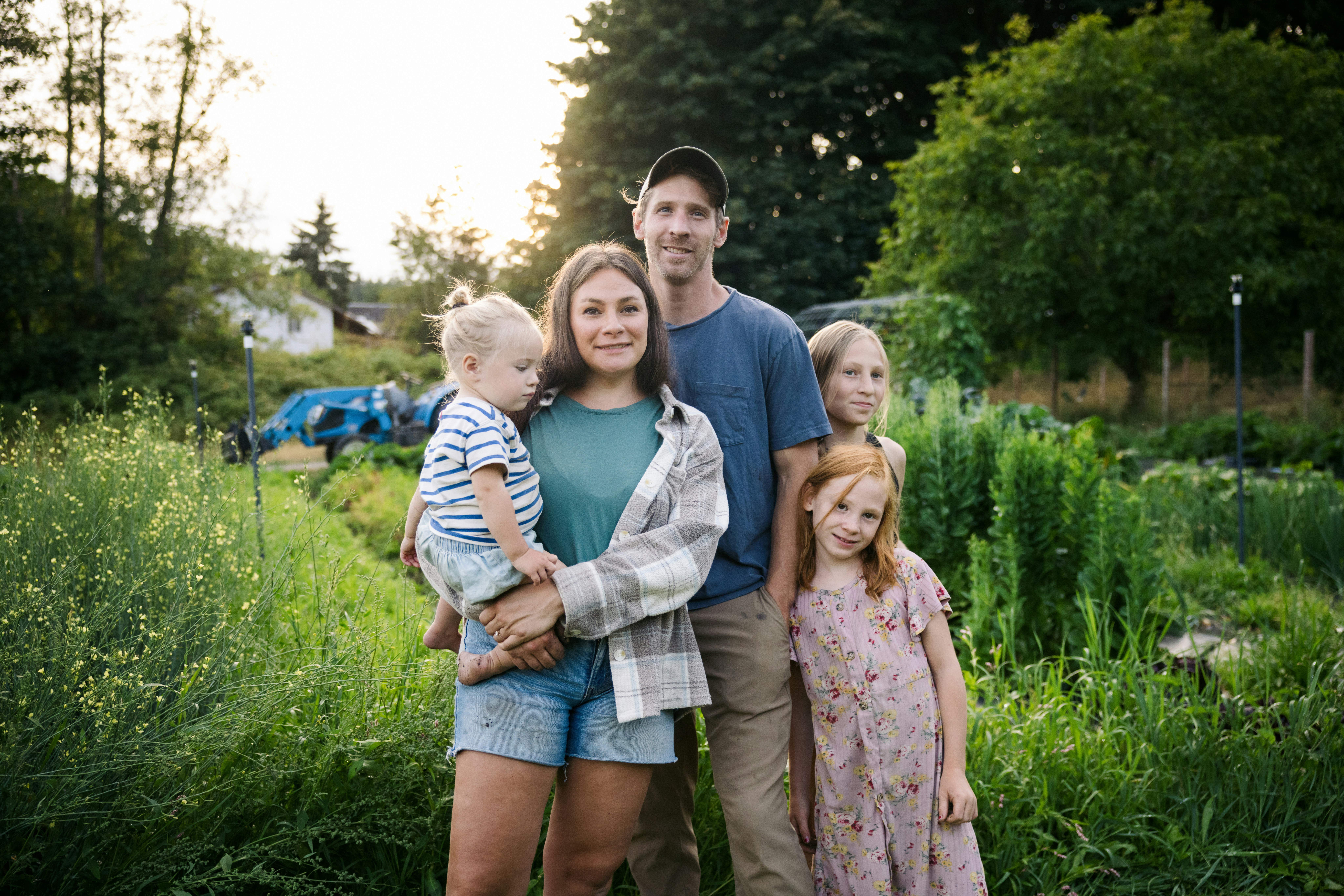 Family posing in a lush garden setting