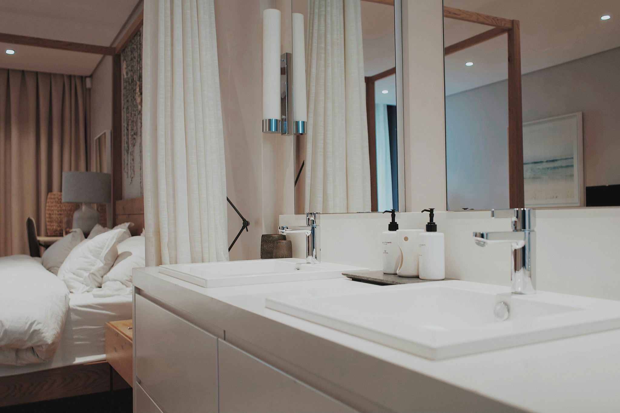a bathroom with two sinks and a large mirror