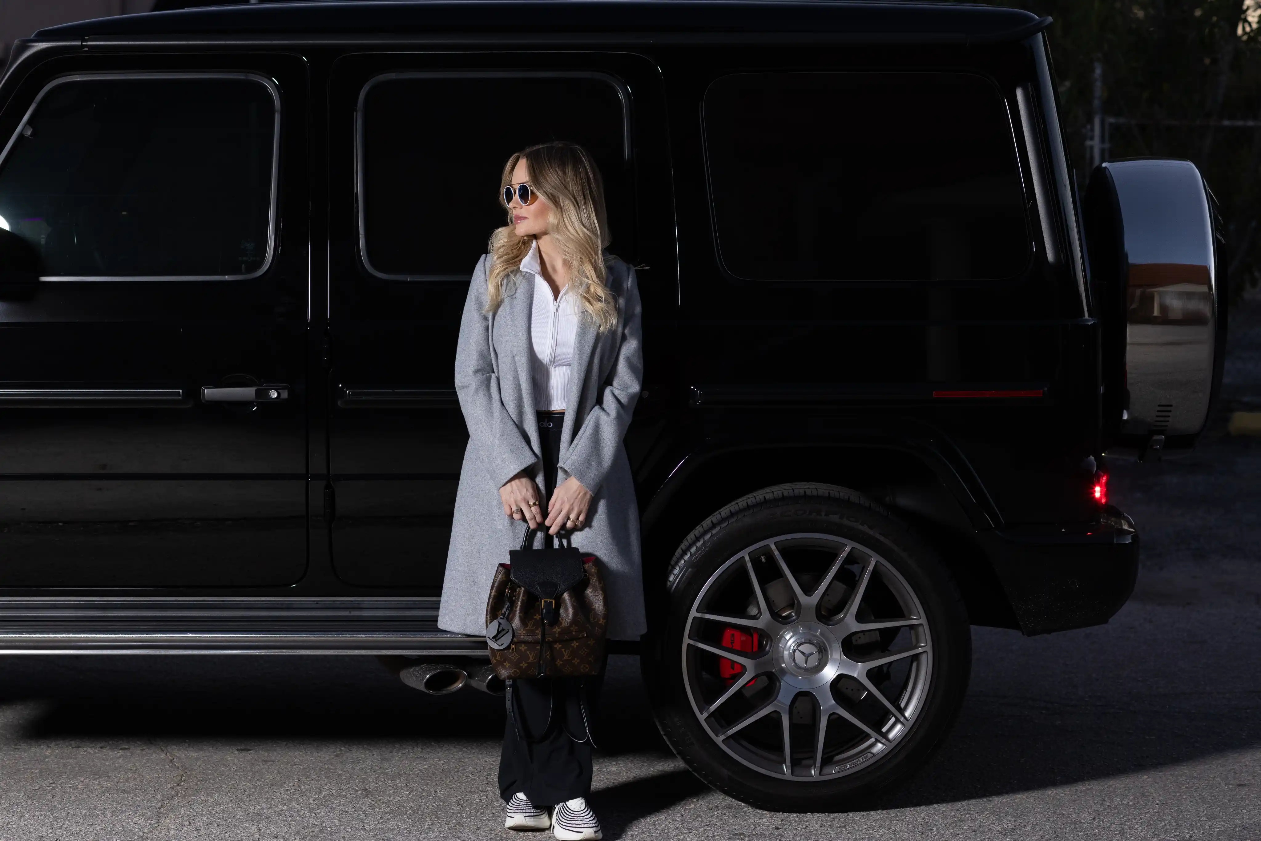 Business founder posed next to a G Wagon in a luxury-style branding photo, part of a Tampa personal branding photography session