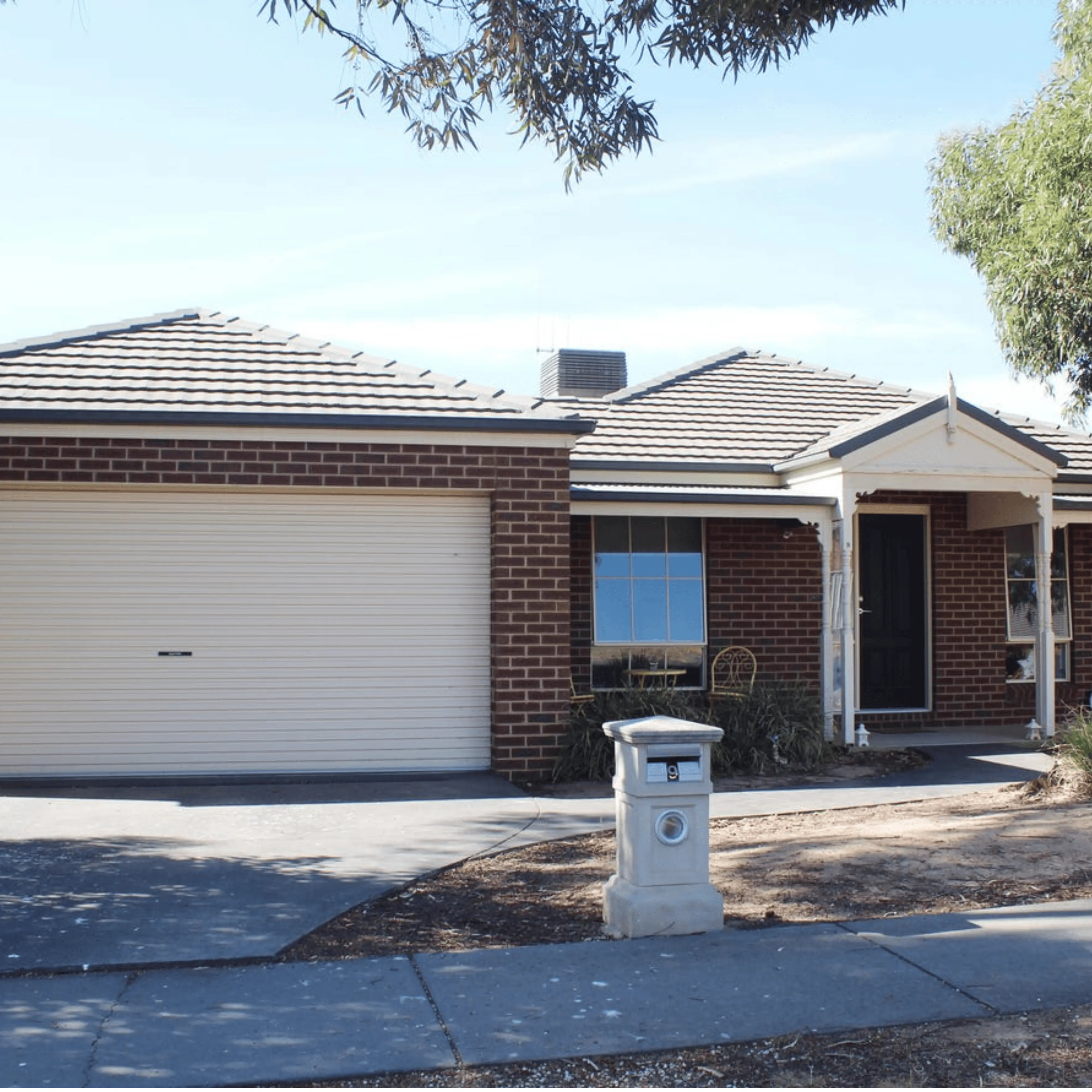 Brick house with garage and mailbox