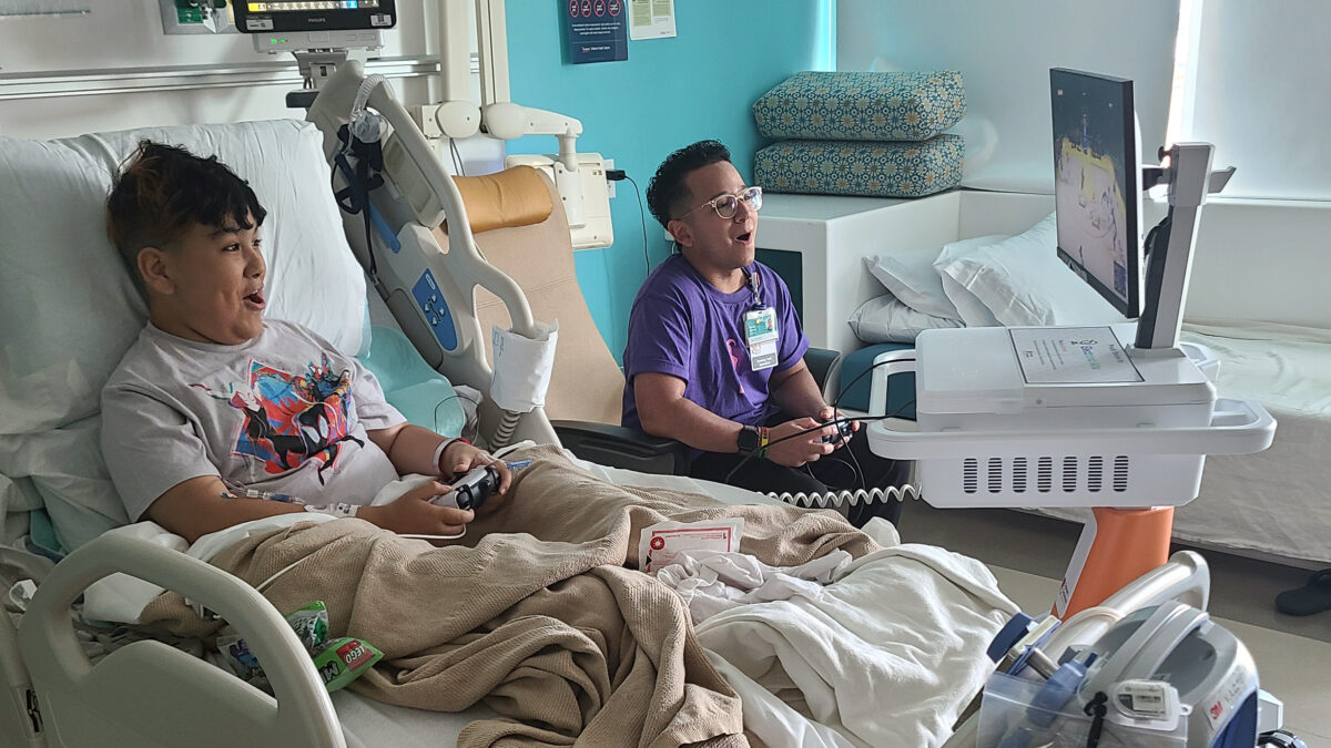 Patient and healthcare staff playing games together on a GO Kart.