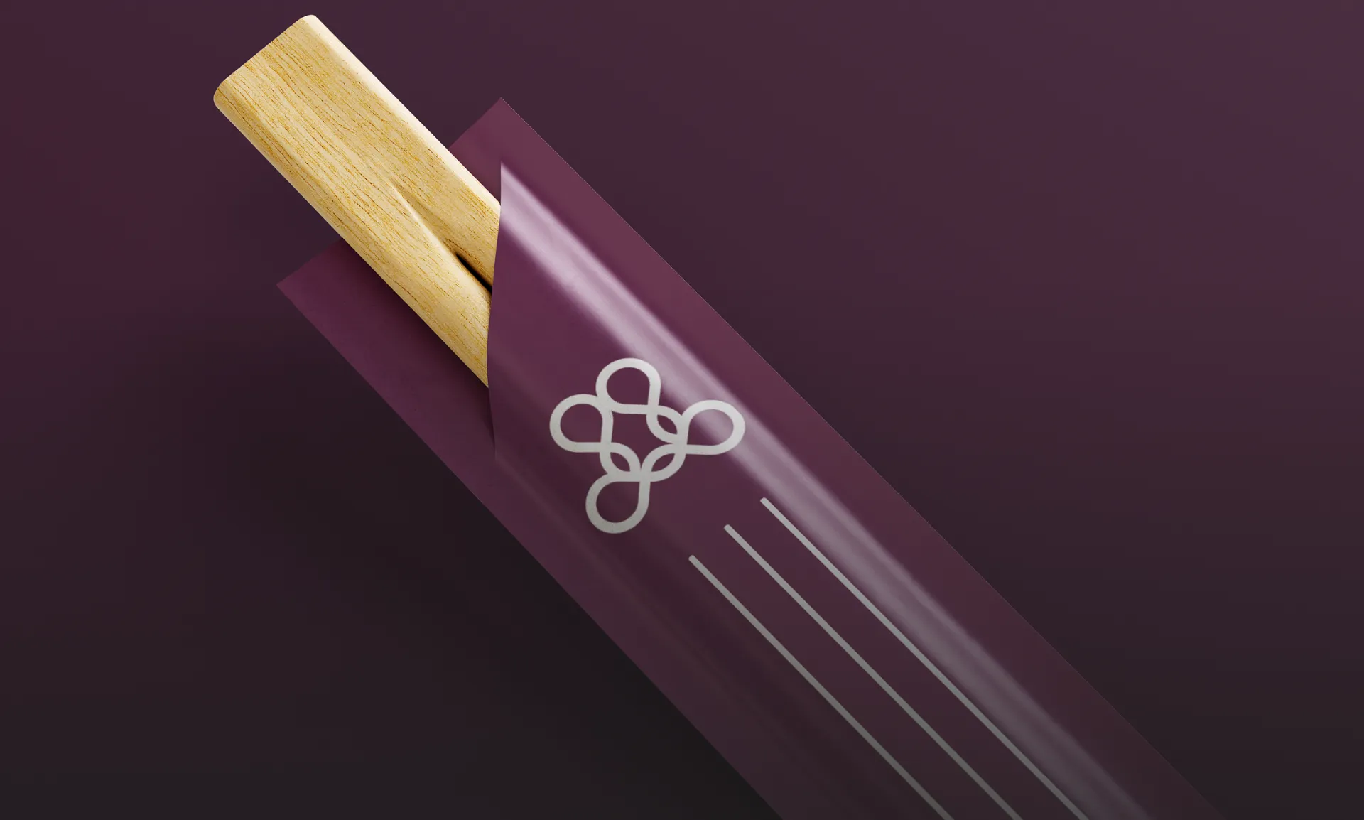 Modern architectural workspace with large floor-to-ceiling windows, surrounded by trees, and desks filled with design materials and books. Two blurred figures are walking through the space.