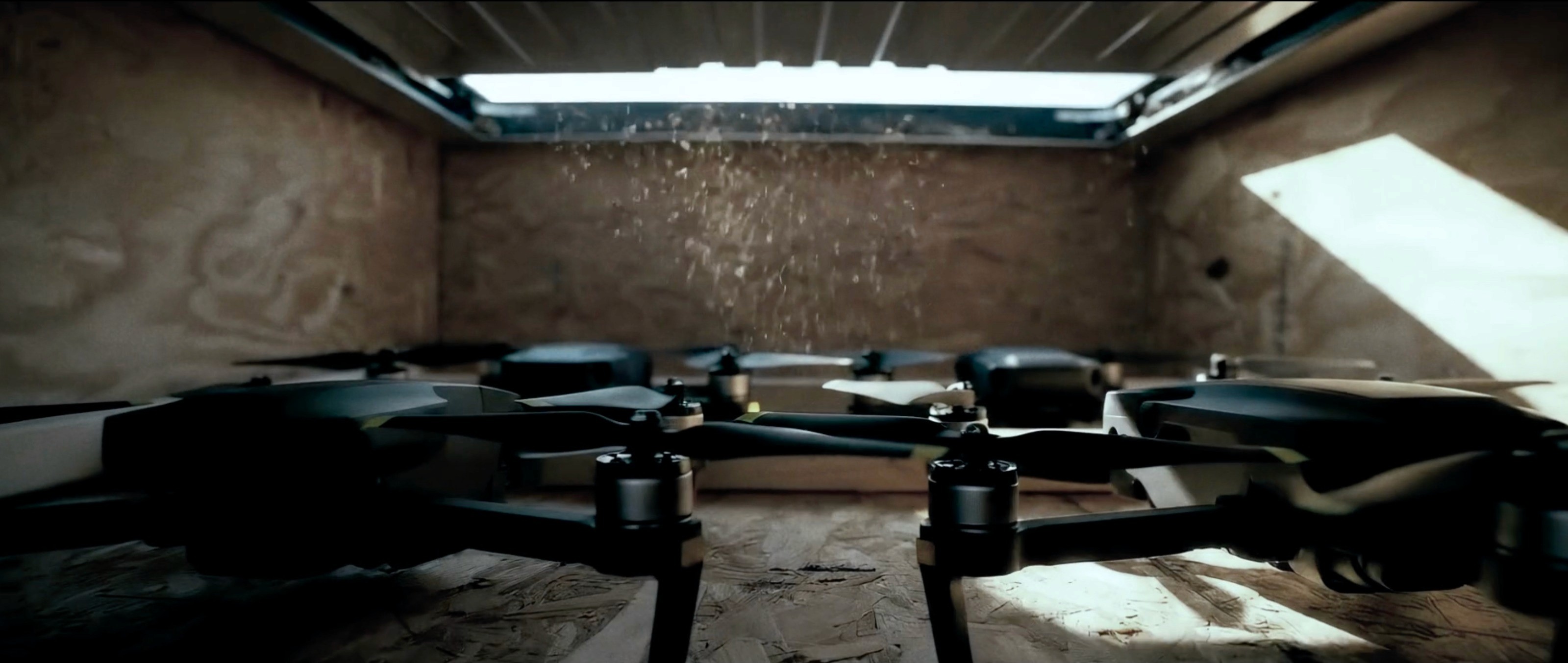 Cinematic AI depiction of drones preparing for launch inside a dimly lit wooden container.
