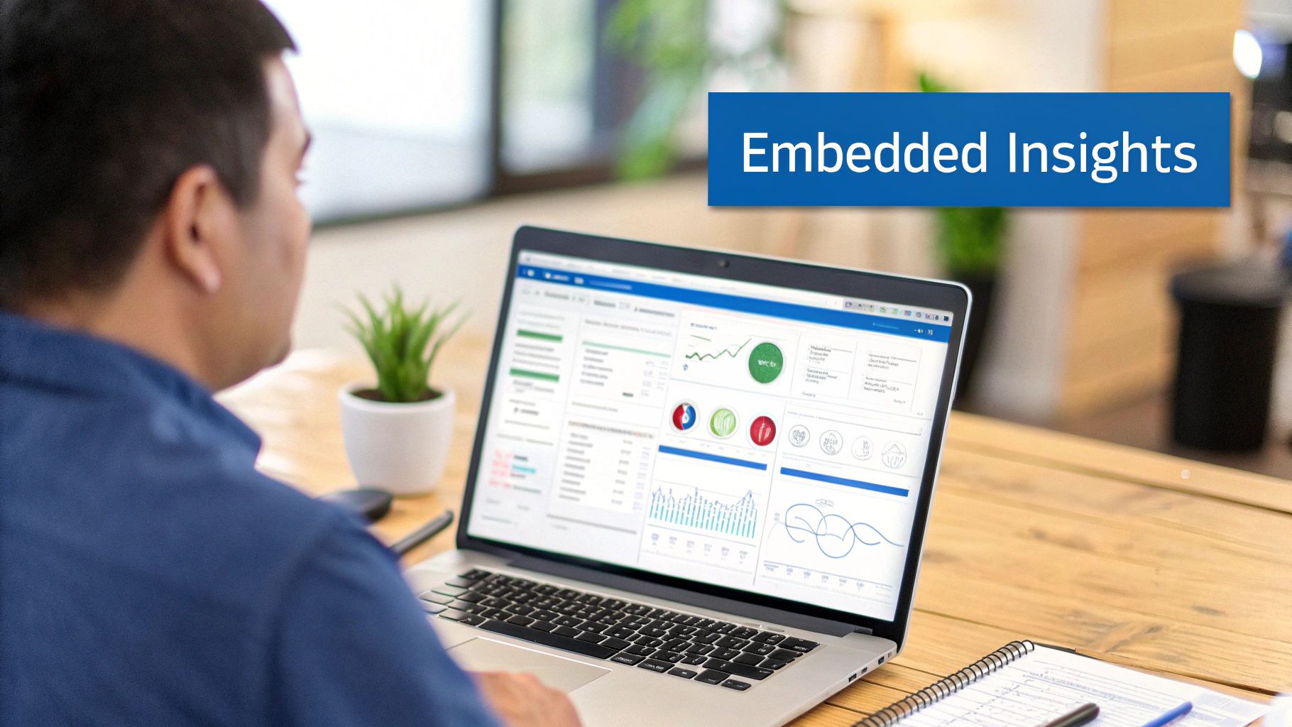 An analyst reviewing embedded analytics dashboards on a large screen