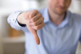 This is the image of a customer wearing a blue shirt and showing a thumbs down for the customer service.