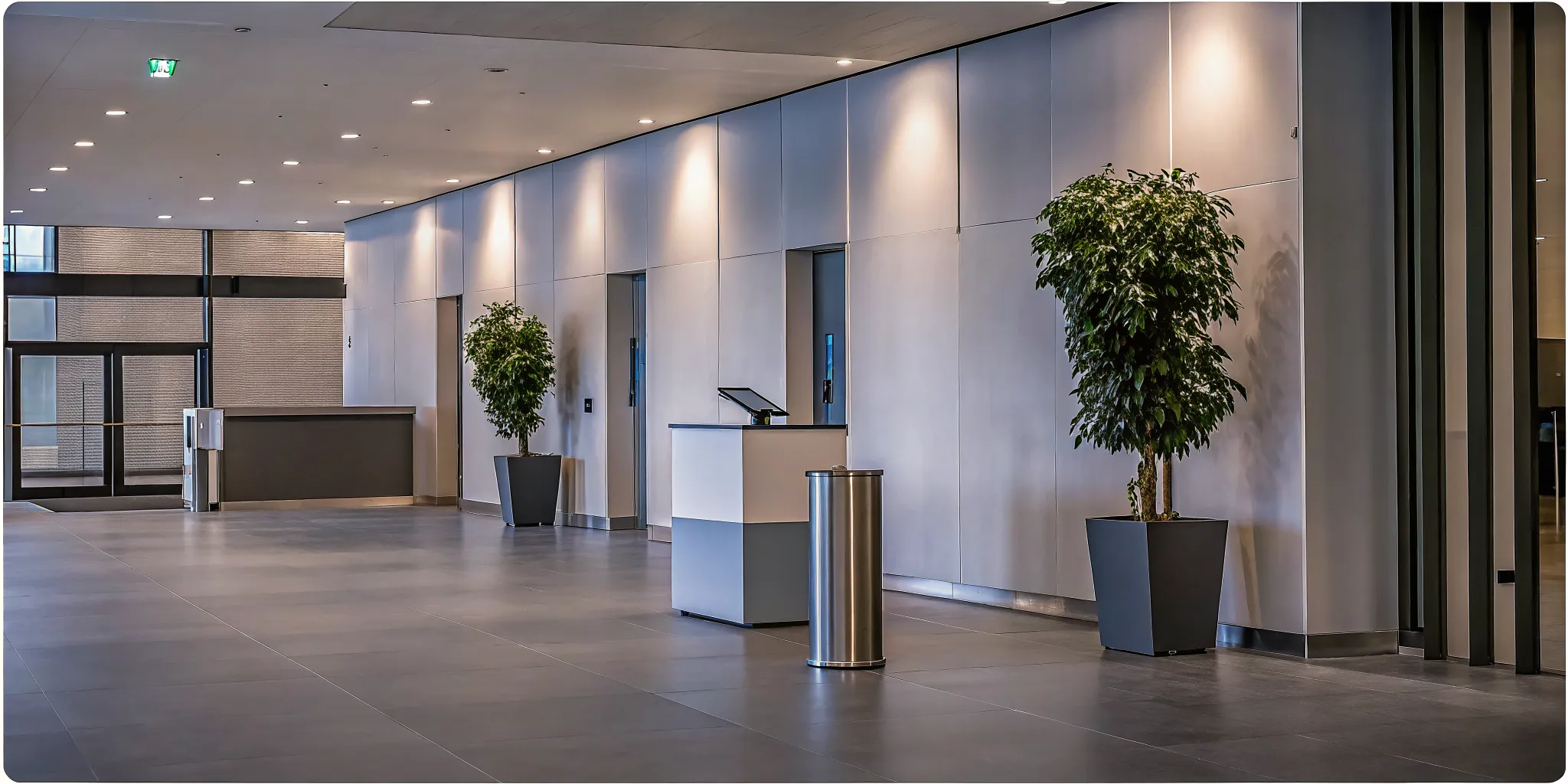 Modern commercial real estate office building lobby with a digital visitor check-in kiosk at the security desk