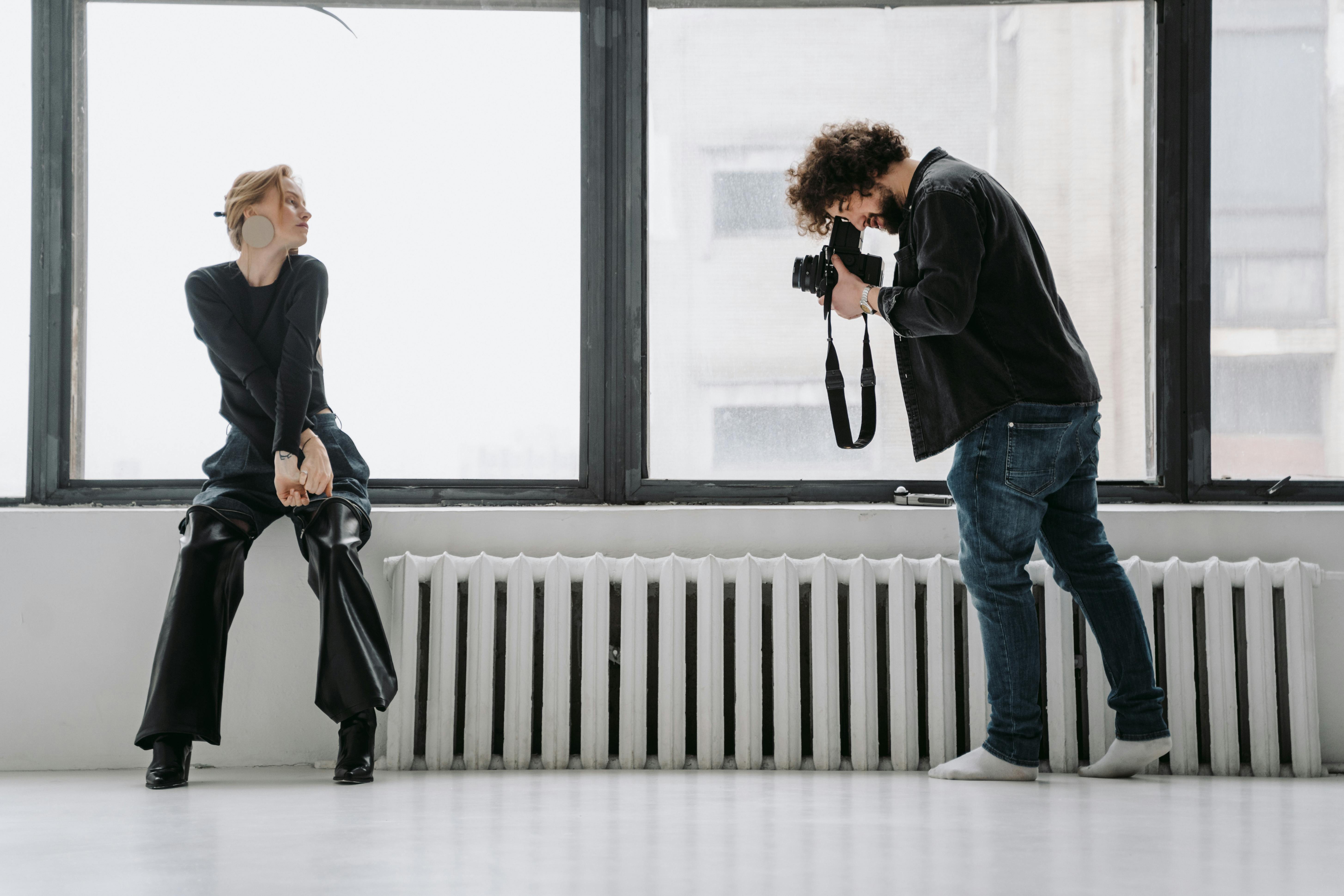 Photographer captures model by window, organizing photos in structured library.