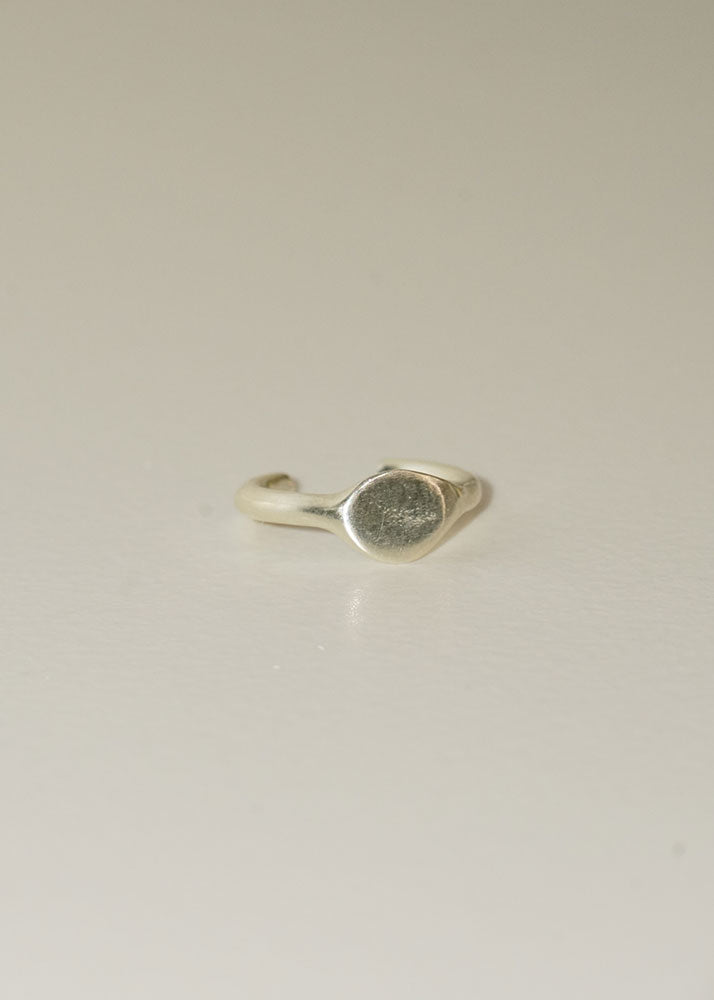 Silver ring on a light beige background