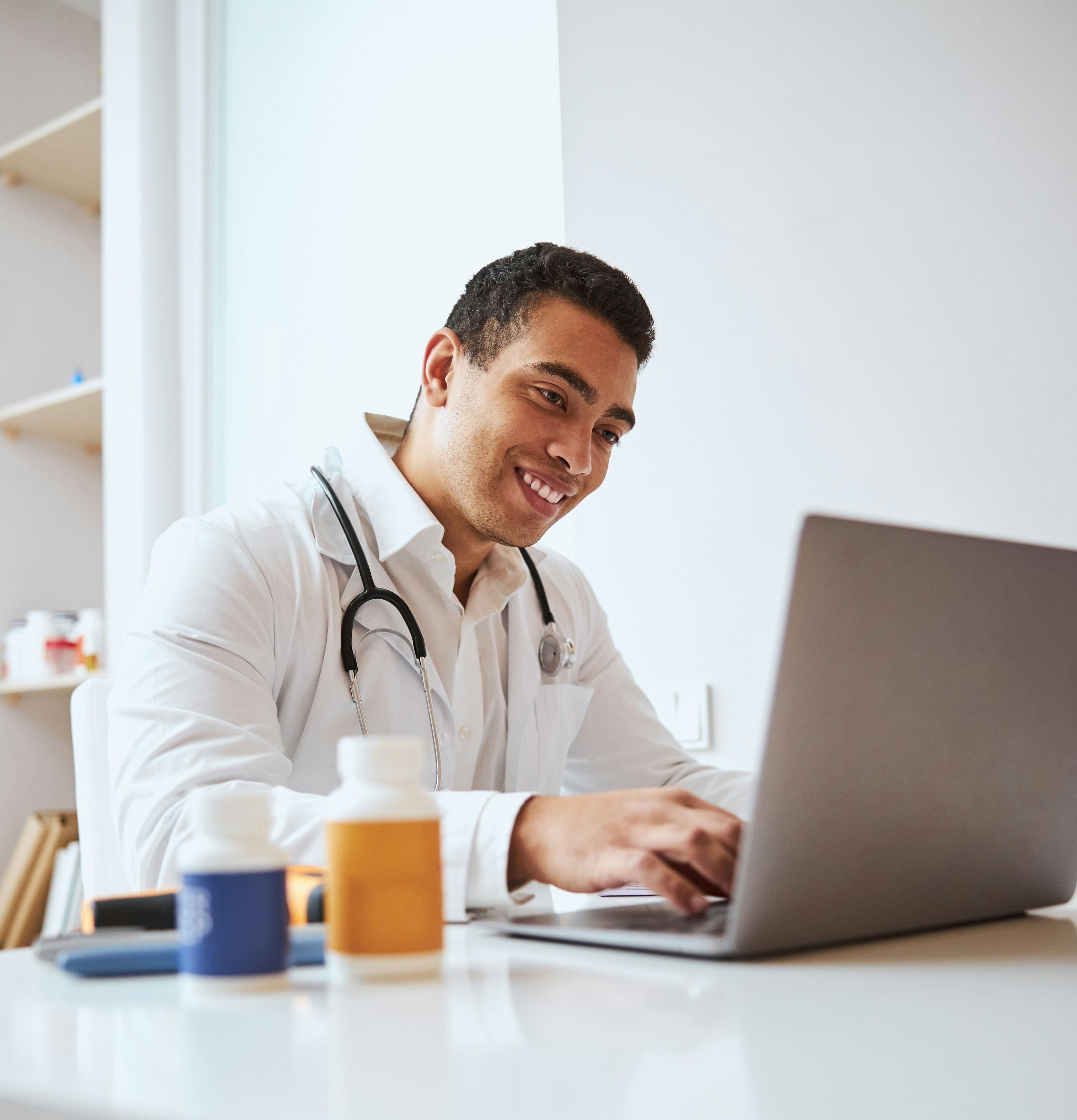 A RevDoc provider sitting next to a woman on a sofa.