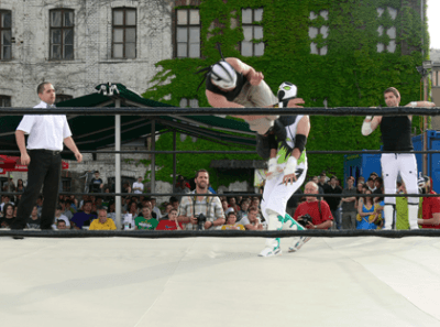 A rustic kitchen scene featuring glass jars of sourdough starter on a wooden table, with a notebook filled with handwritten recipes, a brown bowl of flour, and a beige fabric apron, illuminated by soft natural light from a window.