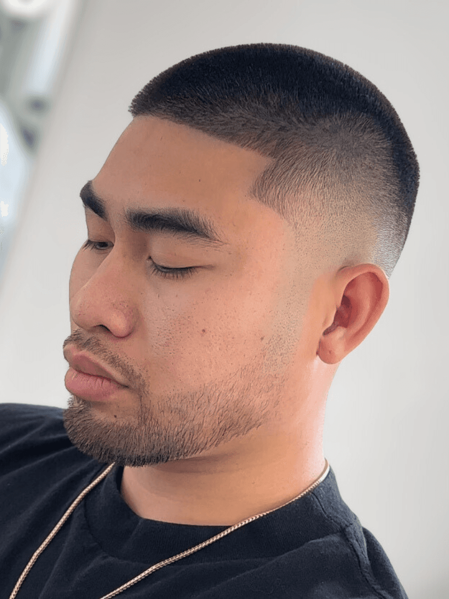 person holding white and gold hair comb