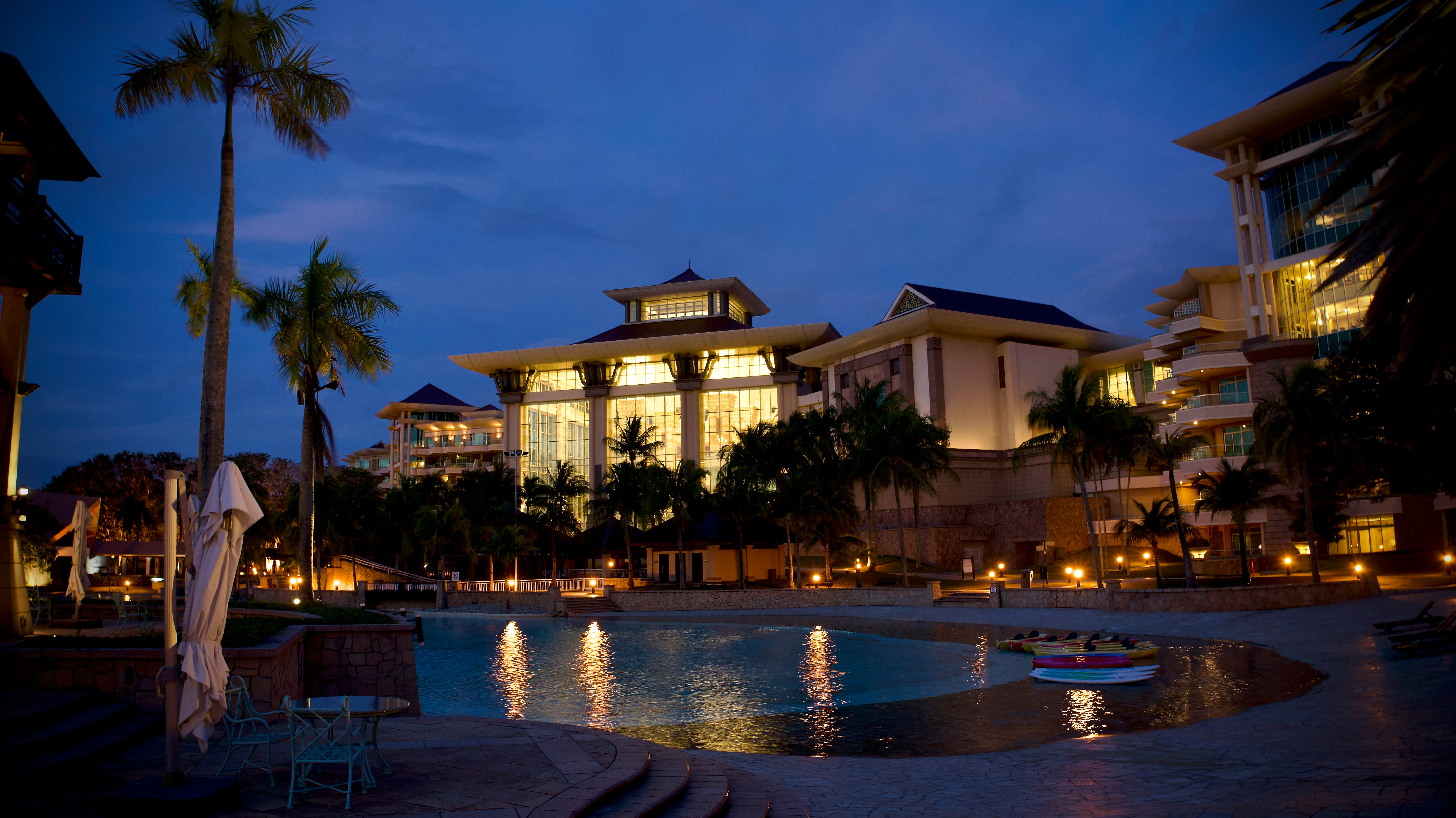 a large building with a pool in front of it