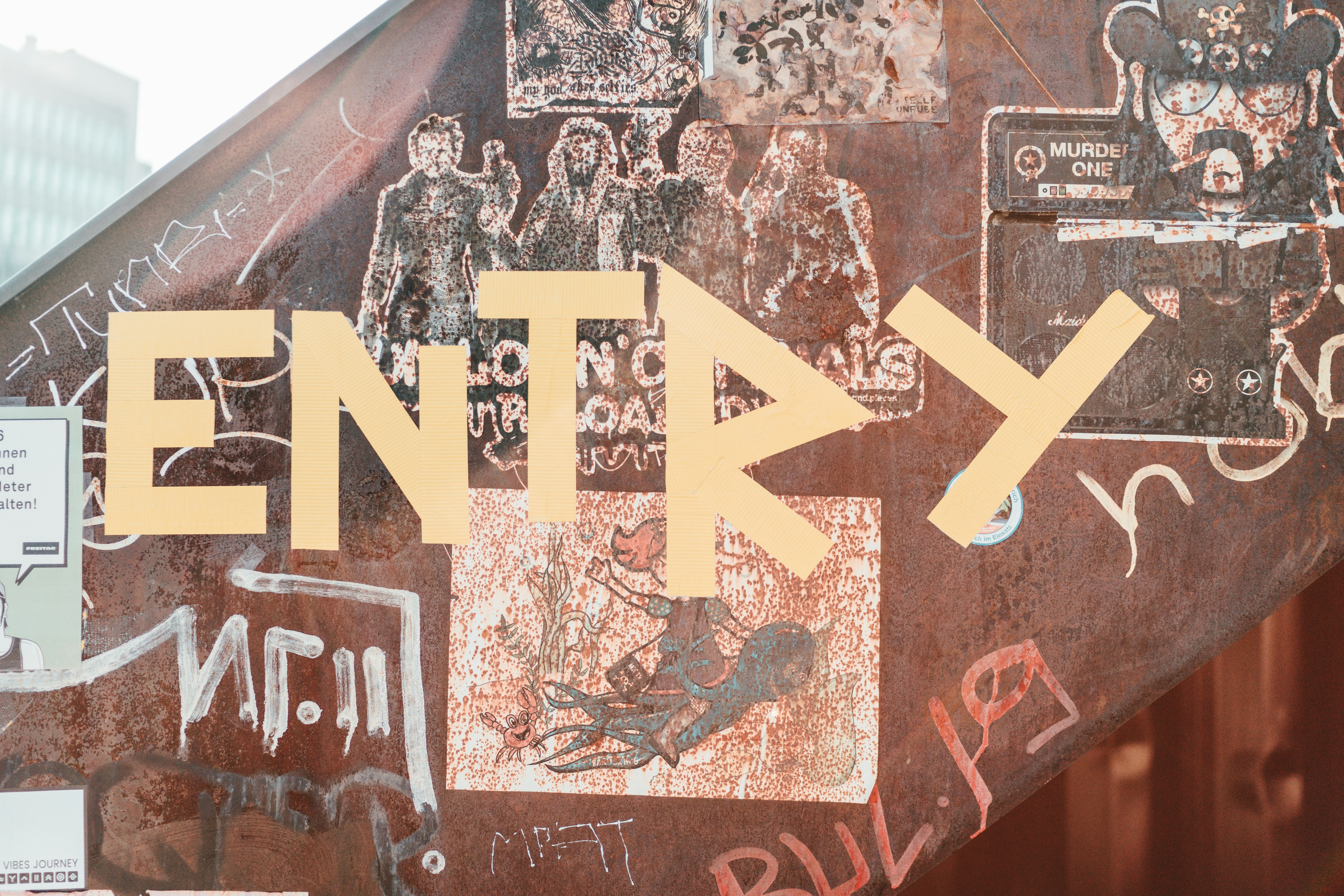 a close up of a street sign with graffiti on it