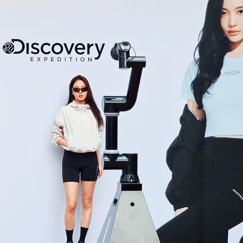 Minimal plant cutting with exposed roots in a clear glass bowl vase filled with water on a white background.