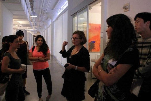 snapshot of a few people talking in a hallway