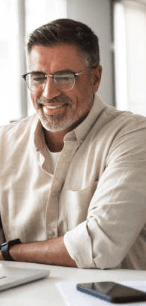 man in black suit jacket holding white ceramic mug