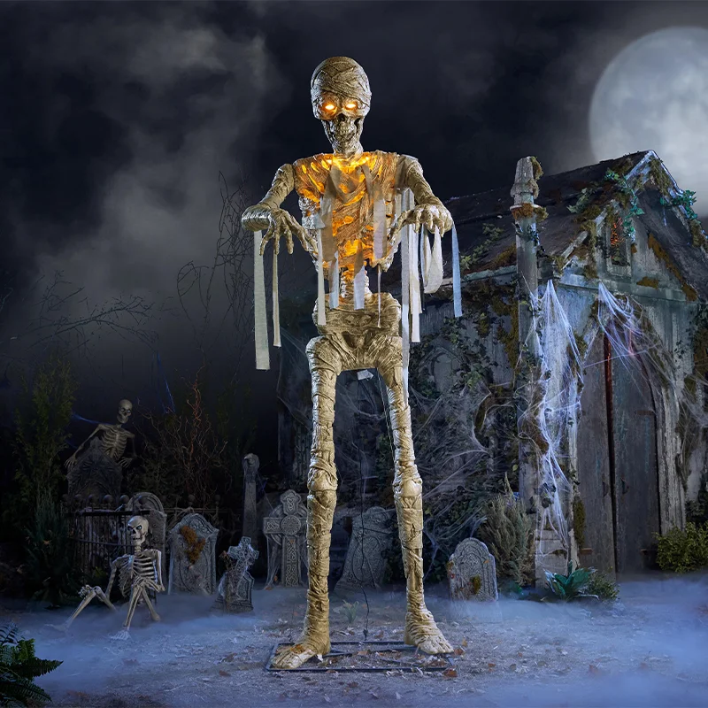 Home Depot 2026 Halloween collection: giant animated mummy skeleton with glowing eyes in a foggy graveyard scene
