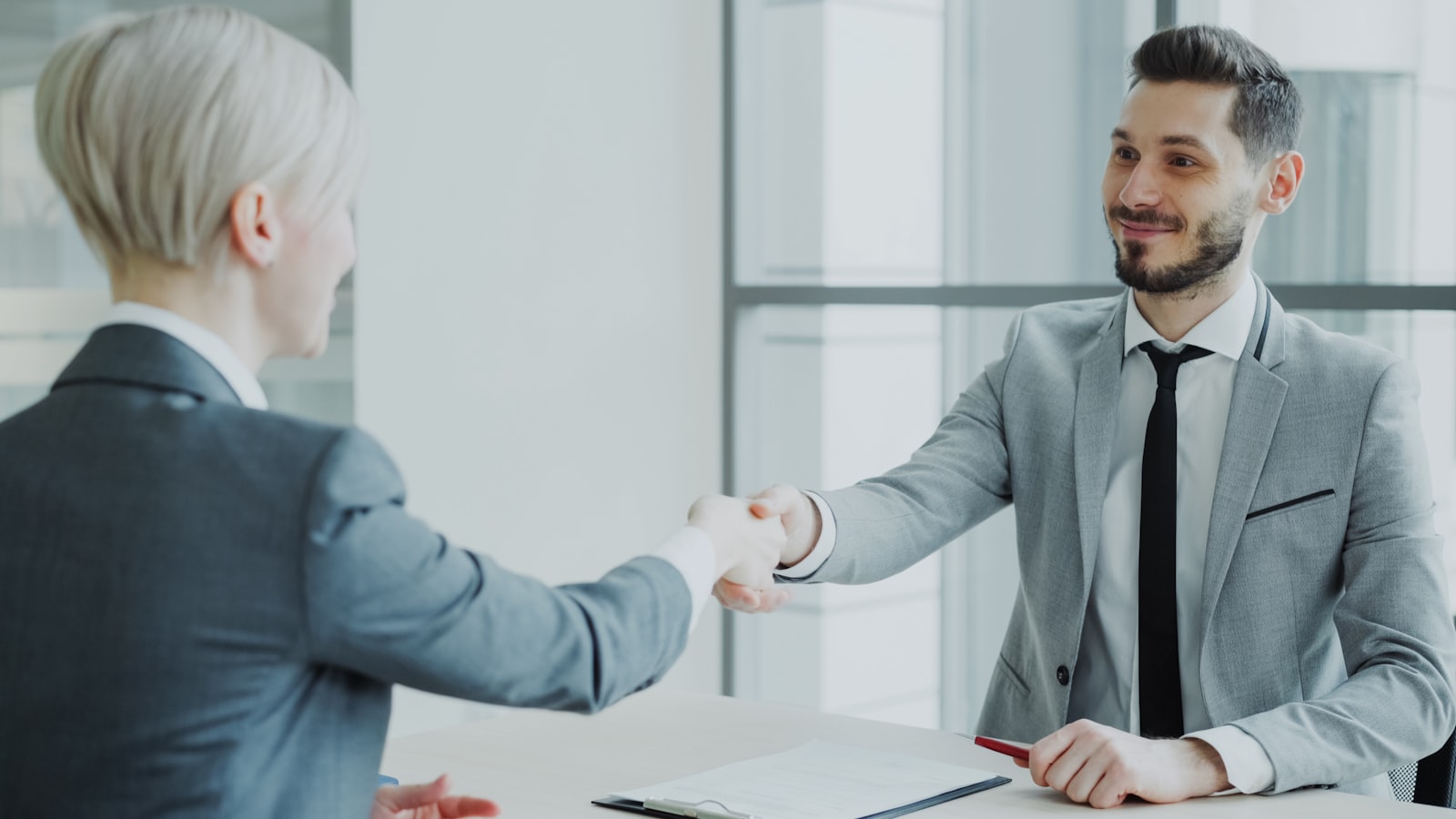 Business owner reviewing managed IT provider checklist.