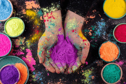 ChatGPT said:  Hands holding vibrant purple Holi powder, symbolizing creativity and color for social media visuals.