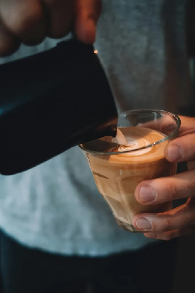 Barista pouring a flat white at Gus Sheffield
