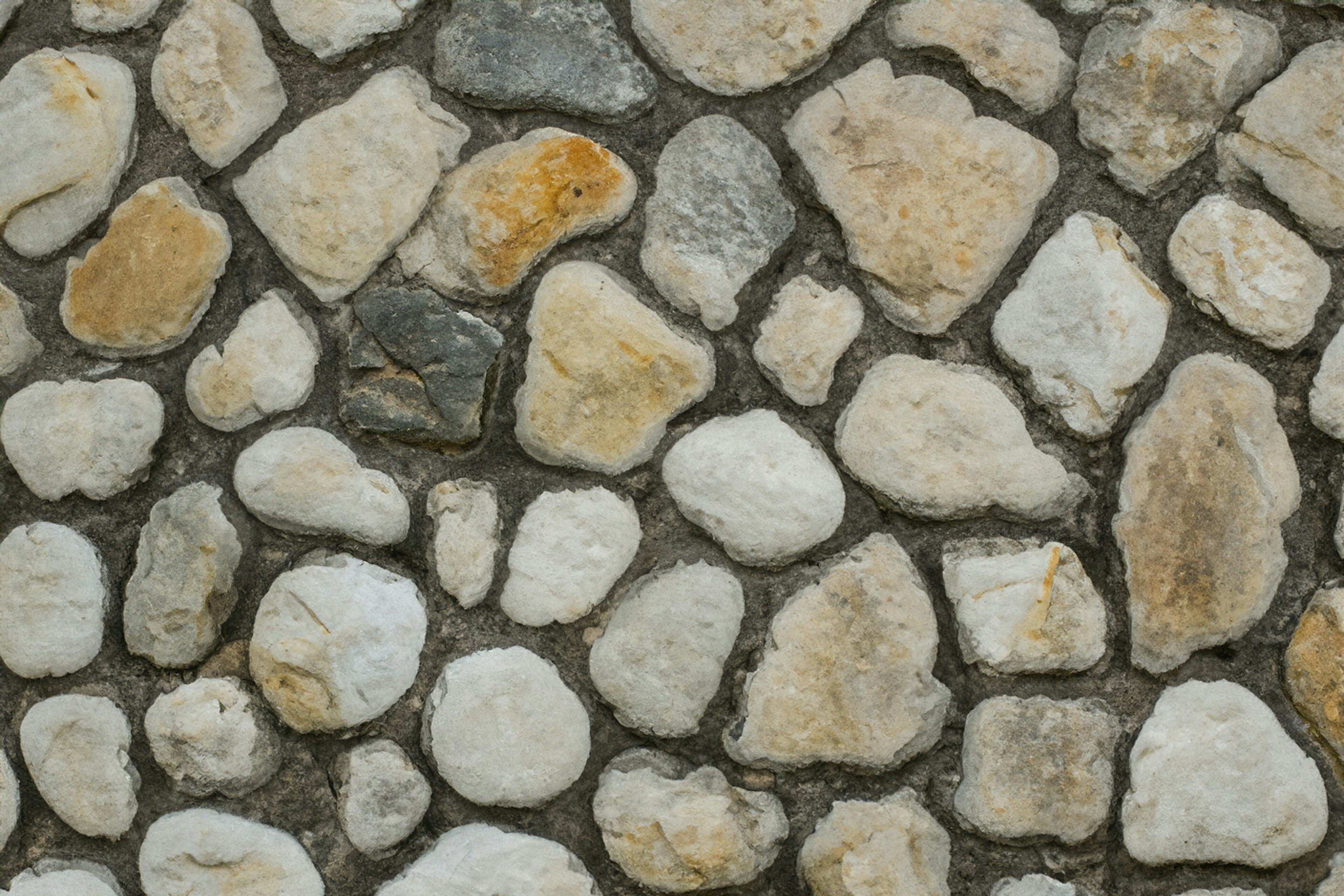 a close up of a stone wall with rocks