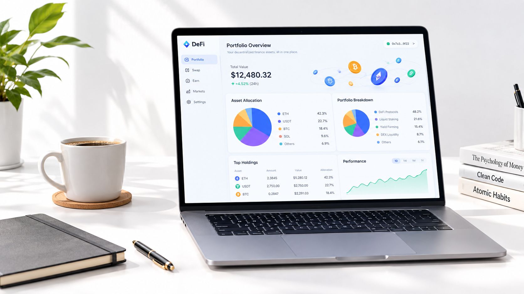 A laptop on a white desk displaying a cryptocurrency portfolio dashboard with charts and financial data.