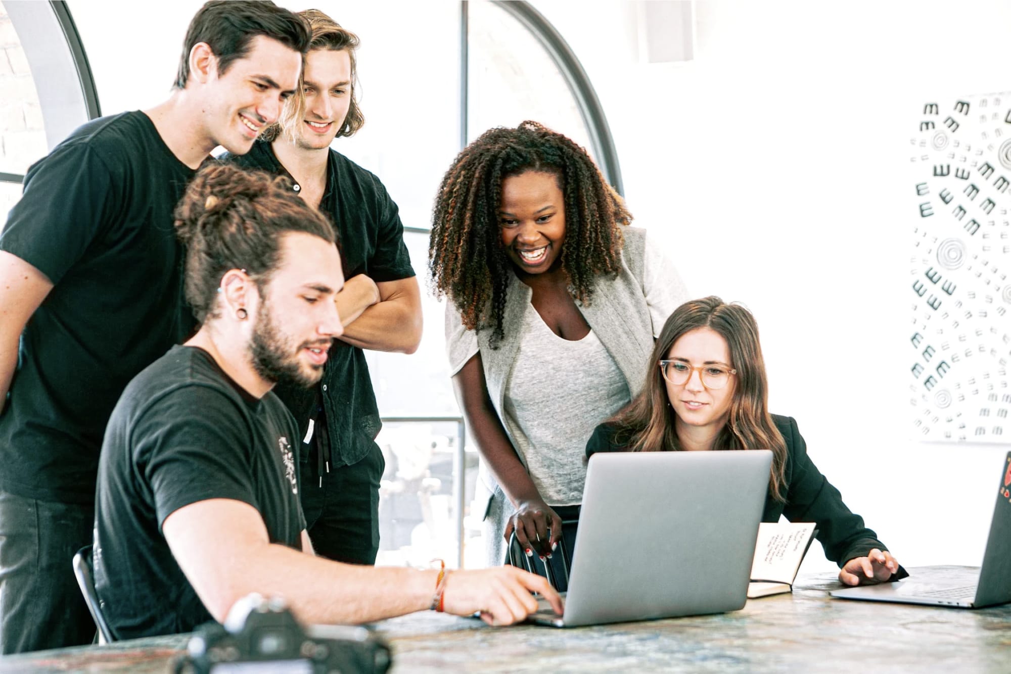 team of people looking at a computer