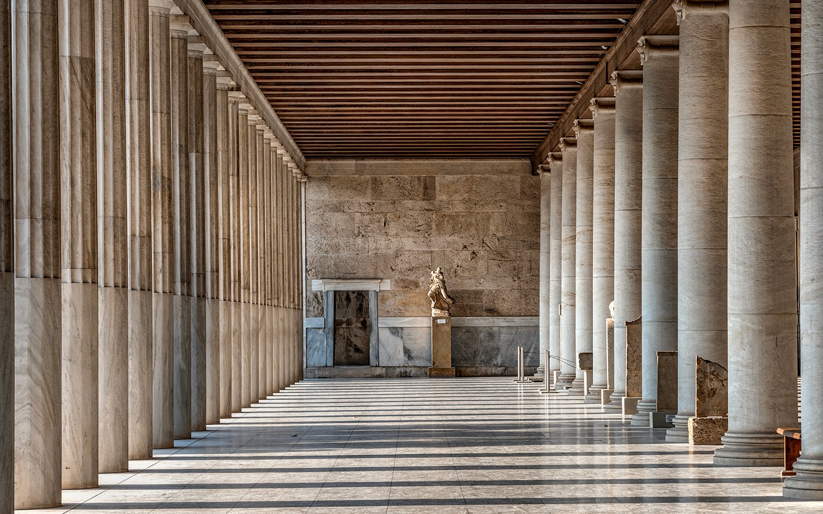 希腊雅典阿塔罗斯柱廊内部的大理石柱与雕像。