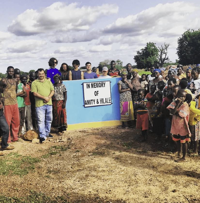red leather handbag on green pine tree