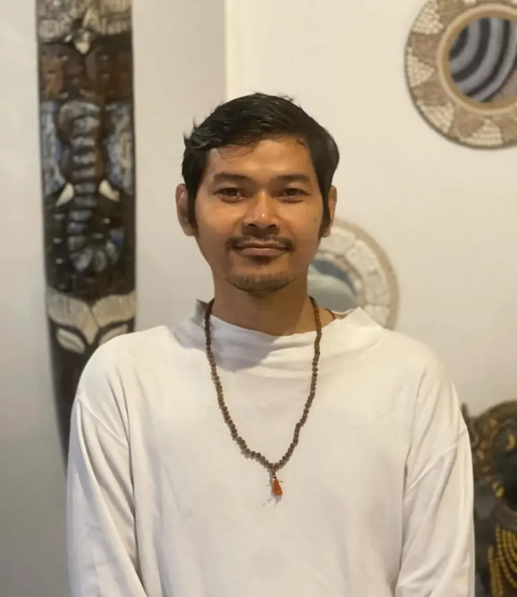 Vivienne Zeng riding a yellow scooter in Bali, enjoying the tropical lifestyle during yoga teacher training downtime.