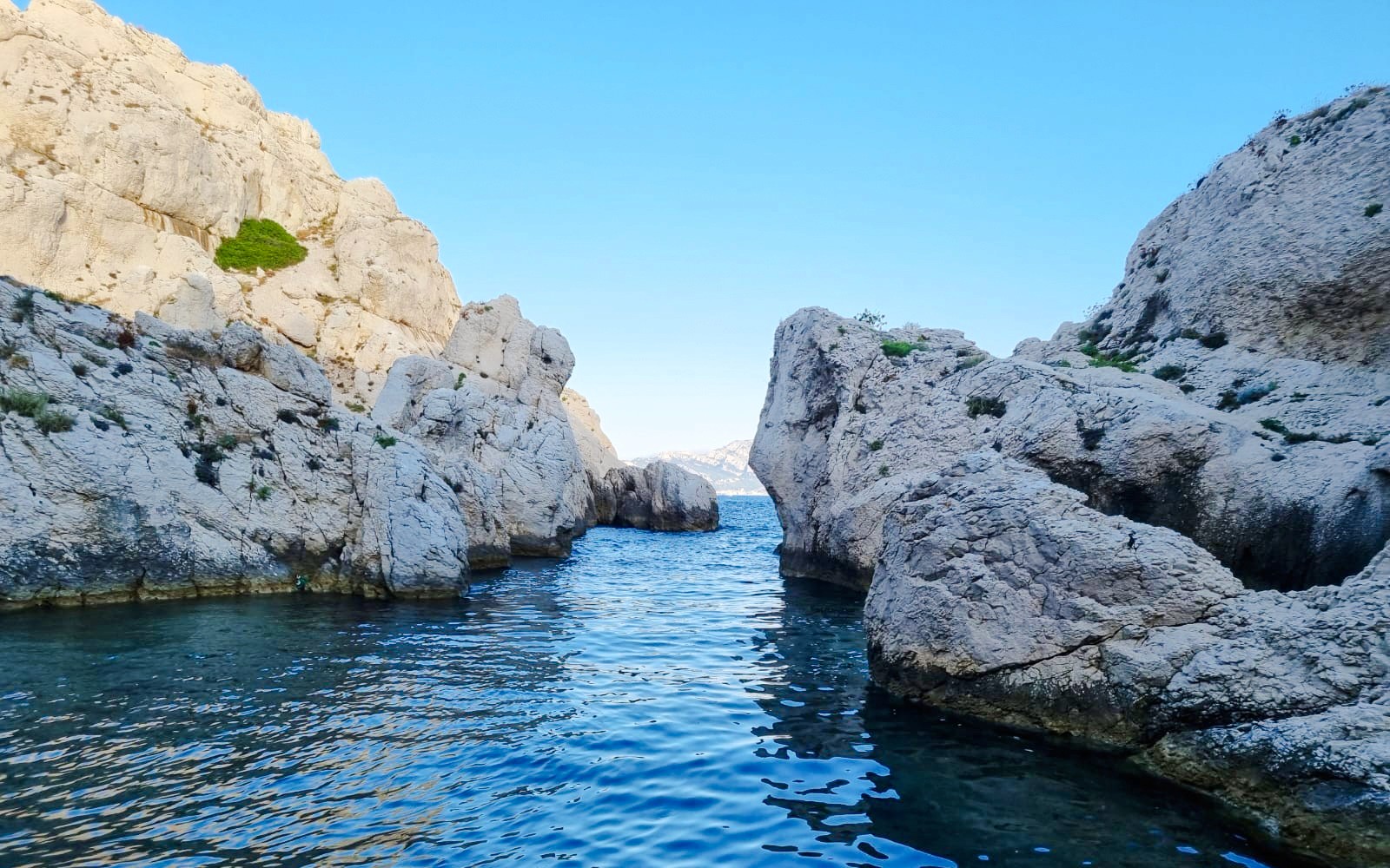 Rocky cliffs and blue water at Massif des Calanques, Marseille.