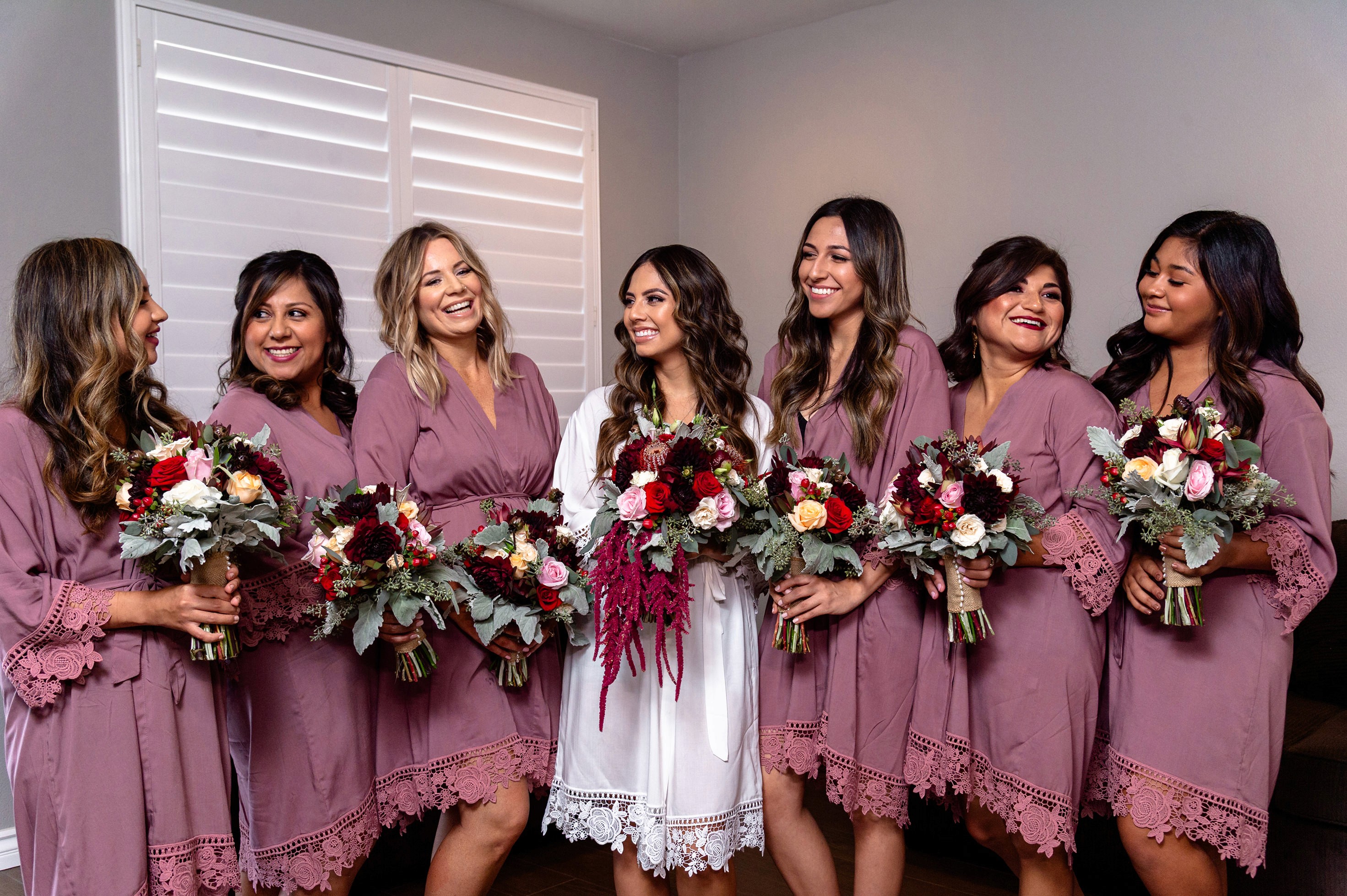 Flat lay wedding details with bouquet, rings, and sparkling bridal heels