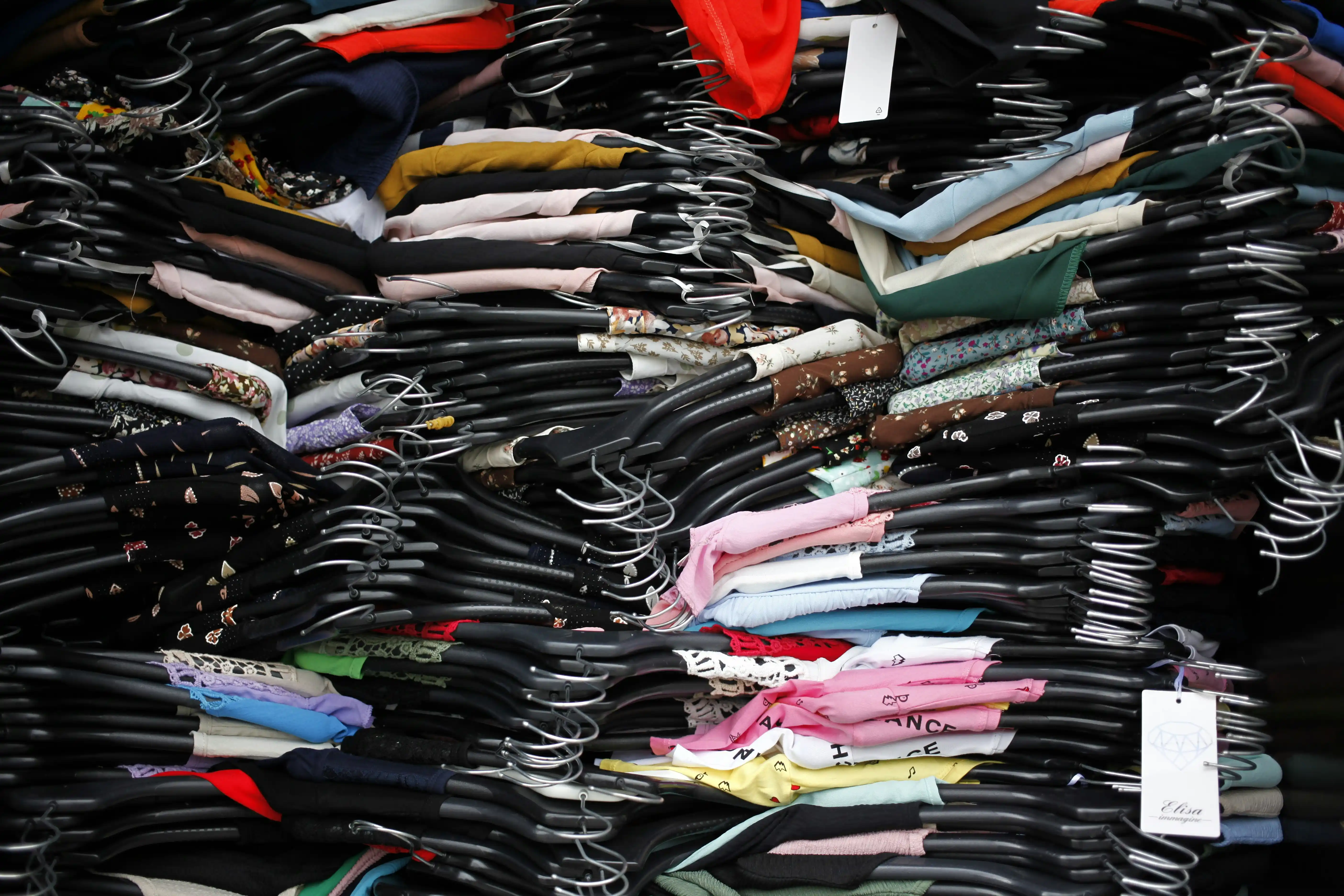 A pile of clothes on hangers.
