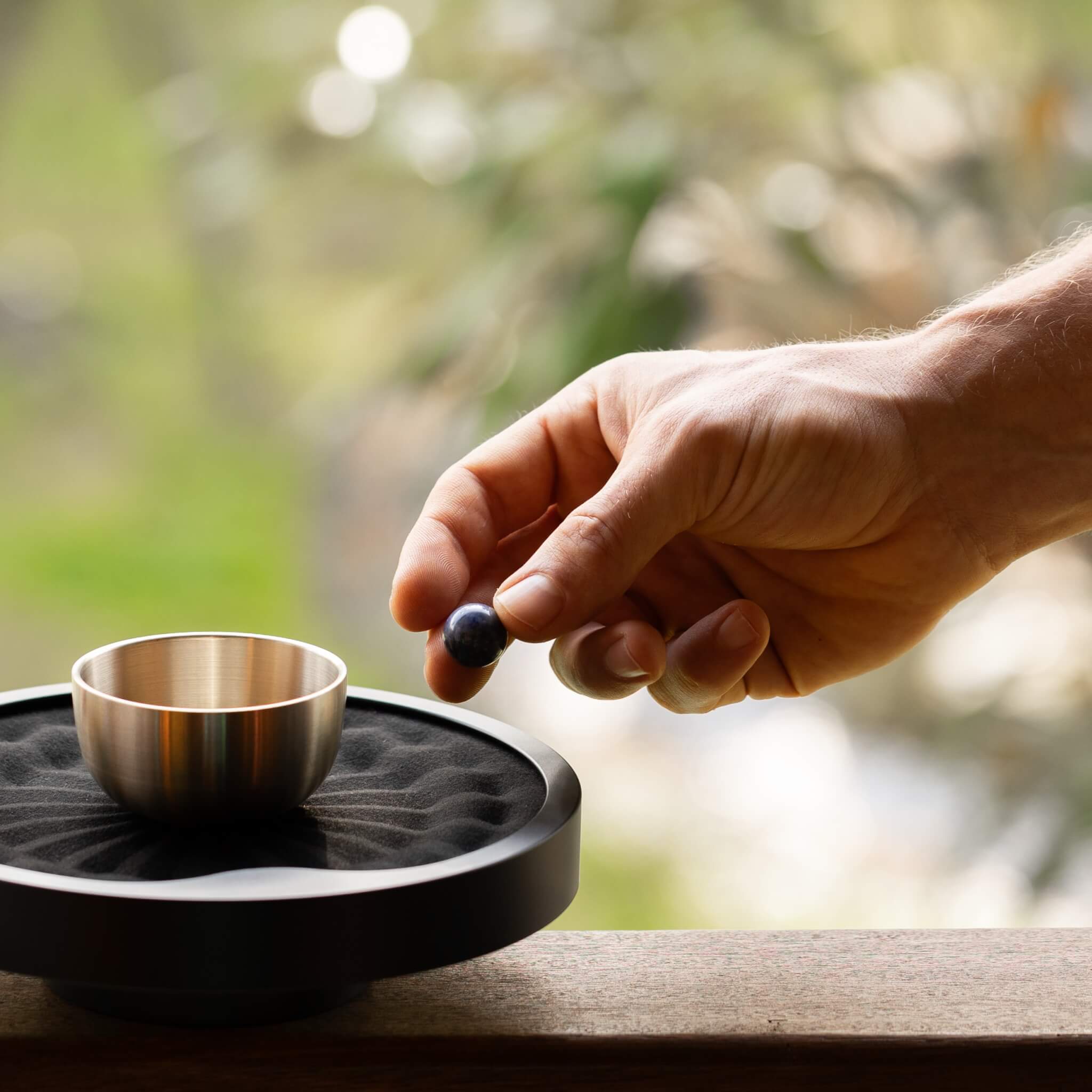 TAOO Kinetic Meditation Timer black close up hand with marble