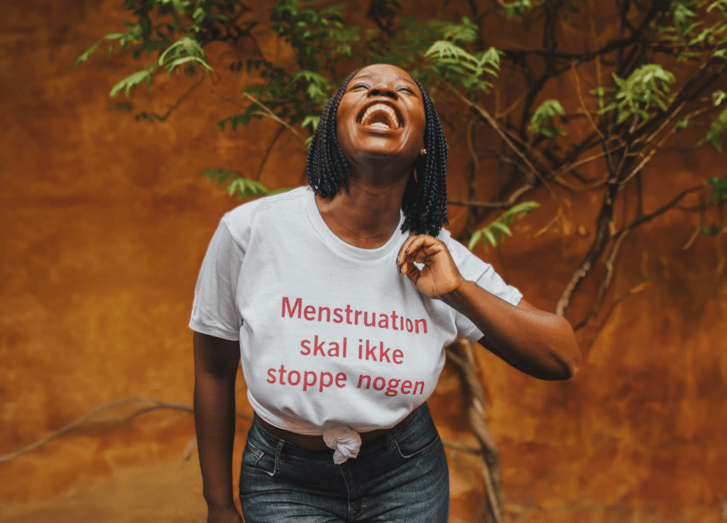 Mary wearing a t-shirt with the text 'Menstruation should not stop anyone'