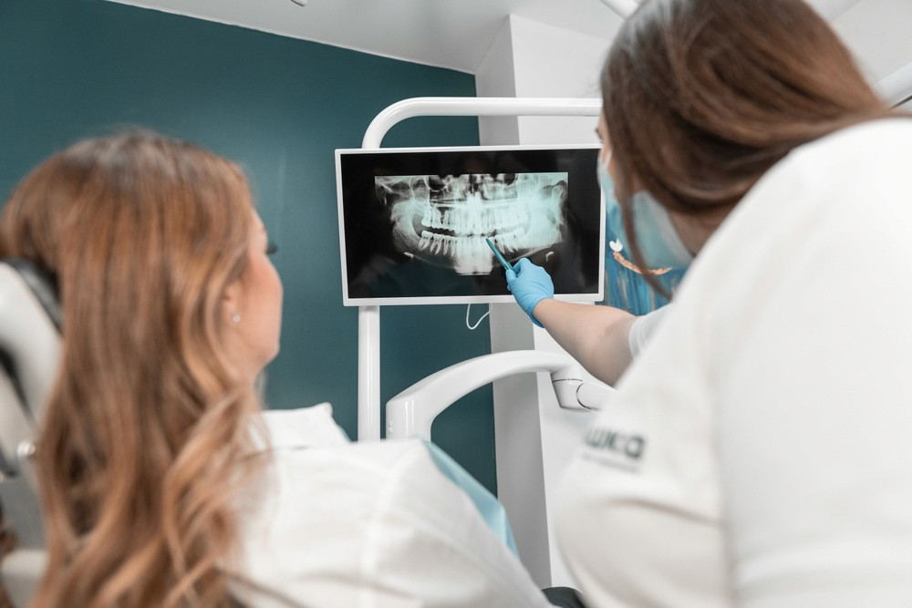 Expert dentist explaining the treatment plan for a personalized Invisalign in Dubai during a detailed smile consultation session